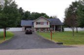front yard view of residential home with pvc vinyl fence in the background for backyard