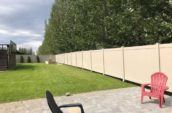 backyard patio with chairs surrounded by pvc vinyl privacy fence