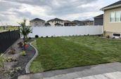 pvc vinyl privacy fence lining far side of home backyard