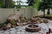 jasper pvc vinyl privacy fence surrounding backyard with stone walkway and garden