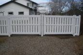 semi-privacy vinyl fence gate in front of home