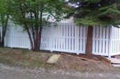 huron semi-privacy vinyl fence gate on the side of home beneath trees